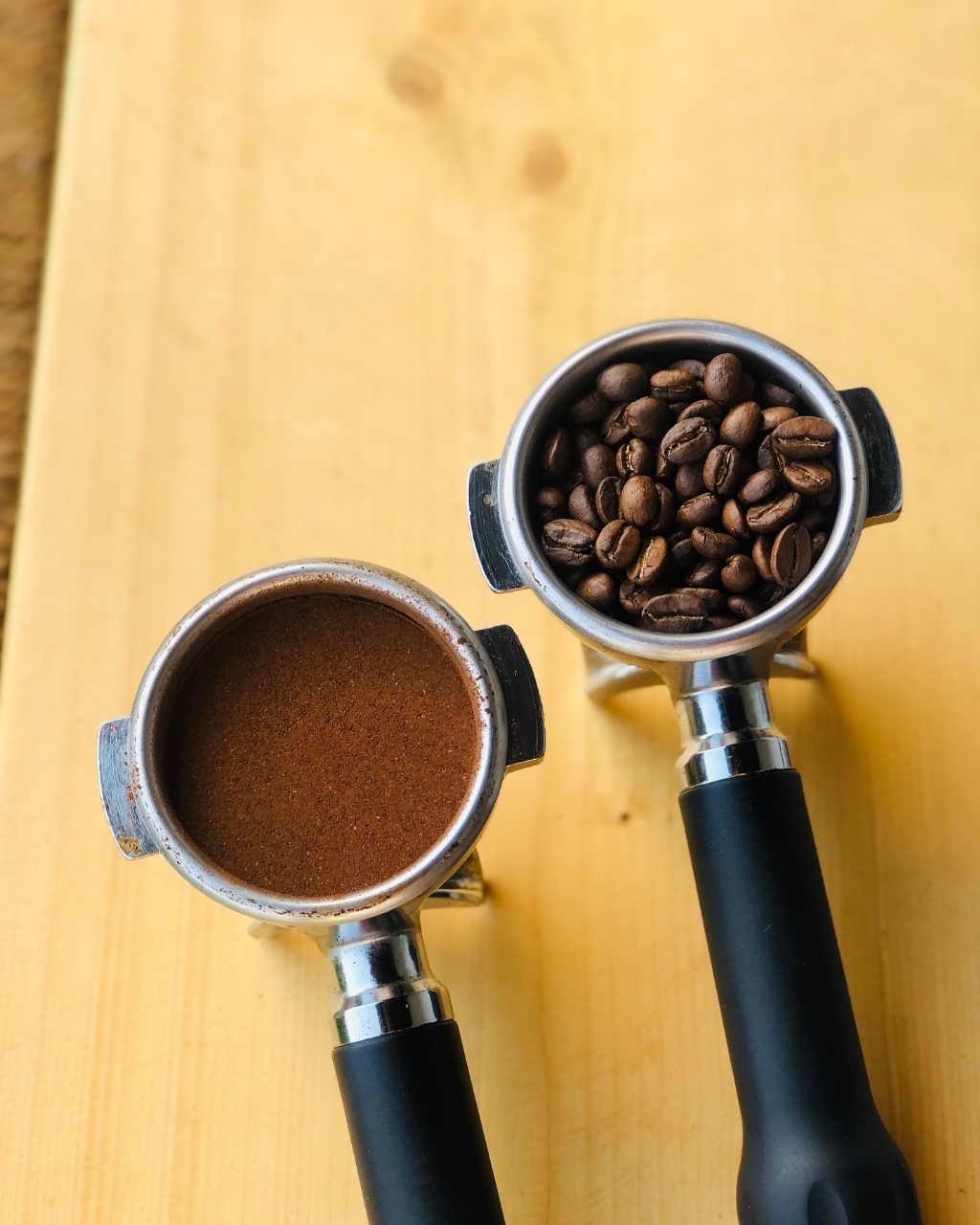 Portafilters with ground coffee and beans